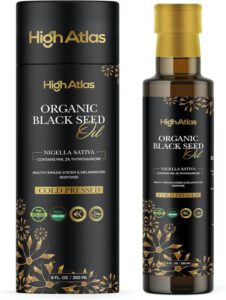 Bottle of organic black seed oil with black and gold packaging.