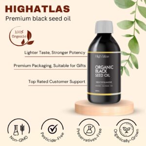 Bottle of organic black seed oil on a wooden base